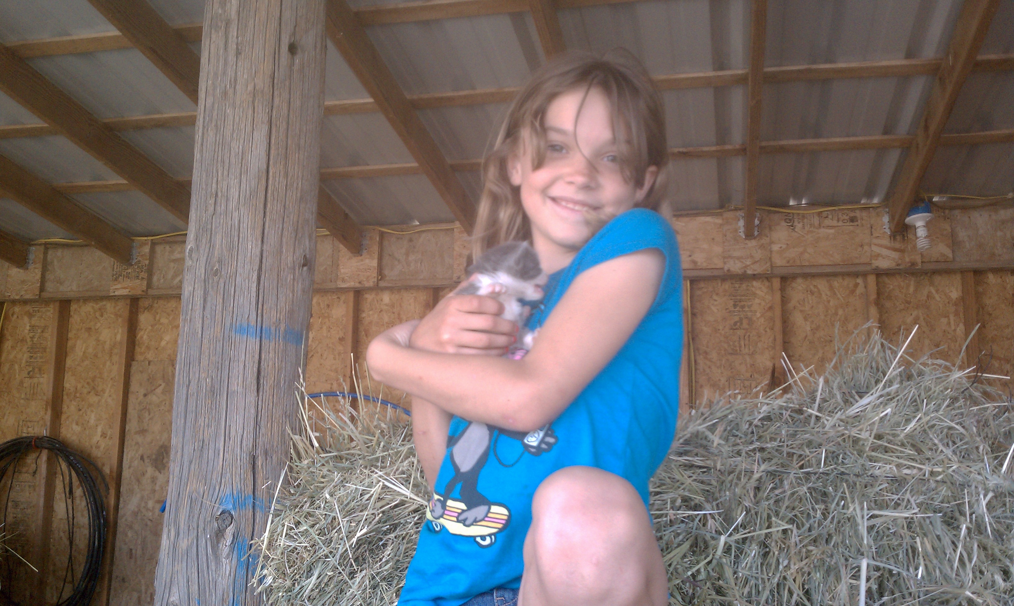 Little Girl holding one of the kittens she bottle fed this year